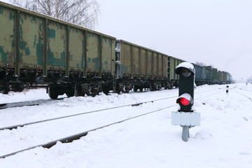 Semaphore at the railway station against the background of the train.