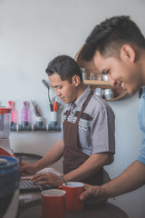 Fototapeta premium two small cafe owner busy working 