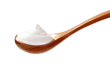cream sour in wooden spoon