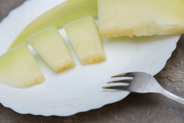 whole and slice of  melons, chopped with seeds