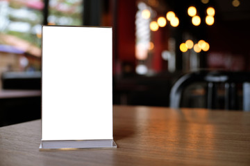 Mock up Menu frame standing on wood table in Bar restaurant cafe. space for text