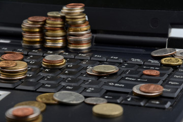 Coins on a laptop isolated on white background