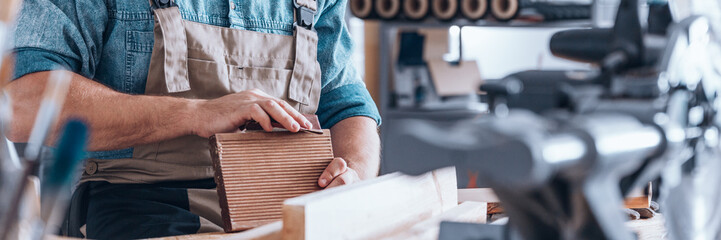 Worker using sandpaper