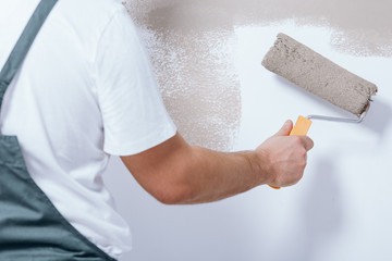 Close-up of handyman holding roller