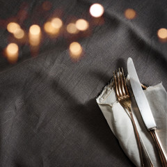 Black linen tablecloth with fine silver cutlery