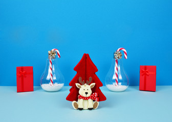 Christmas composition with Santa, decorative christmas tree, gifts and candy canes.