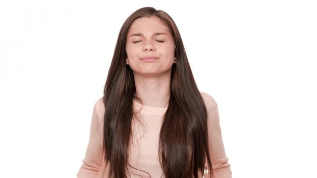 Close up portrait of caucasian female teen being sleepy yawning covering open mouth and her eyes with hands over white background. Concept of emotions