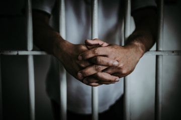Fototapeta na wymiar Hands of men desperate to catch the iron prison,prisoner concept,thailand people,Hope to be free.