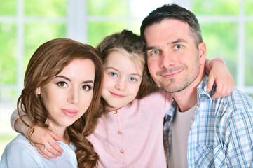 Fototapeta premium little girl hugging parents