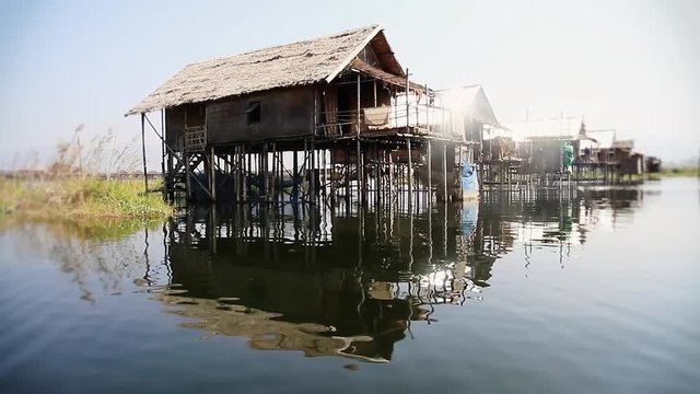 Huts on the Inle lake at day time. Shot from a small boat in Myanmar in 2014