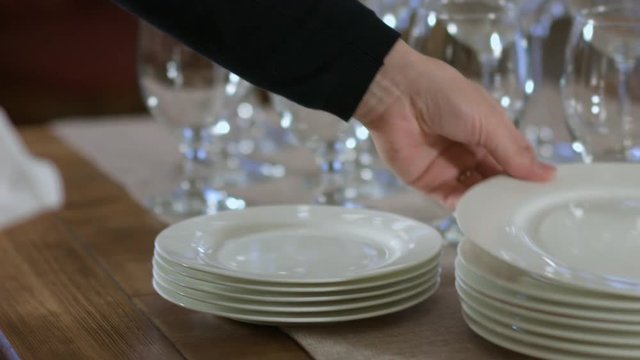 Waiter wiping a plate