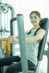 Attractive Asian woman doing exercise at gym. Woman exercise concept.