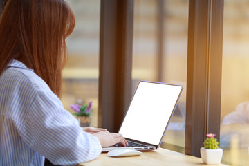 Freelancing woman using laptop computer for distance job while sitting in coffee shop. Business woman typing on laptop at workplace Woman working in home office hand keyboard.