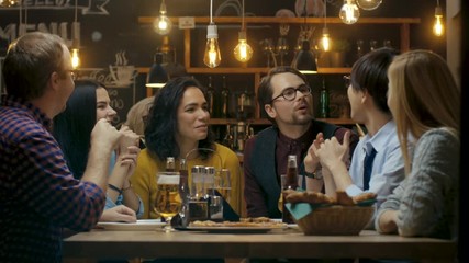 Diverse Group of Young People Have Fun in Bar, Talking, Telling Stories and Jokes - Powered by Adobe