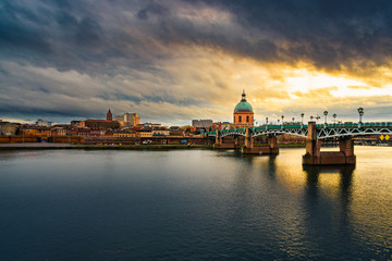 Naklejka na ściany i meble Stormy skies over Toulouse & the Garonne River during golden hour