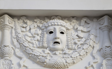 Plaster mask on the wall of the theater.