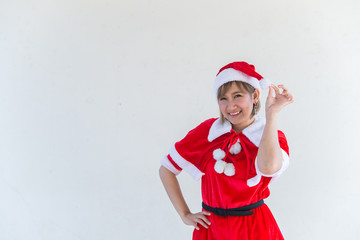 Obraz premium Beautiful young asian woman in Santa Claus clothes on white background,Thailand people,Sent happiness for children,Merry christmas,Welcome to winter,Happy woman concept