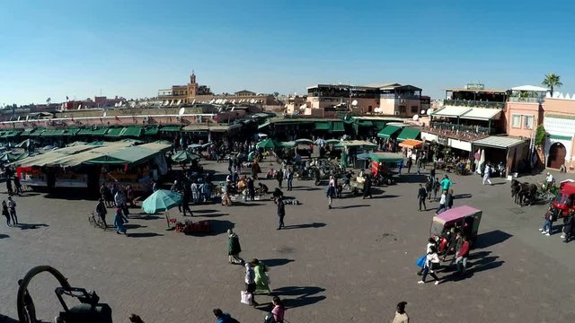 Jamaa el Fna square market place in Marrakech with lots of people walking around &ndash; 4K