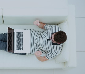Young man using his laptop, close up