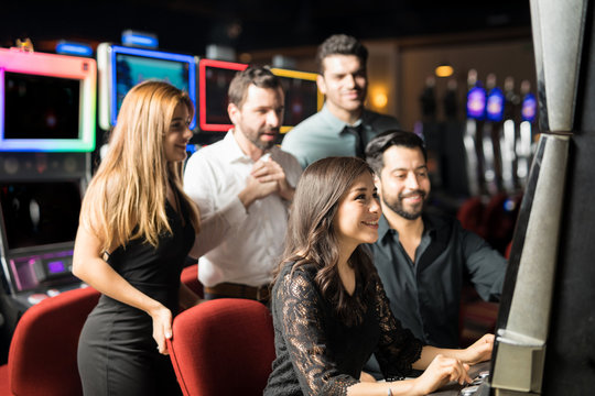 Group of people playing in slot machine
