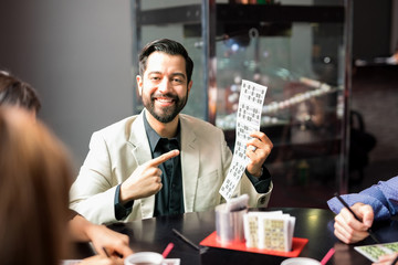 Latin man winning a lottery game
