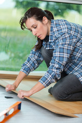 woman using tools to fit floor