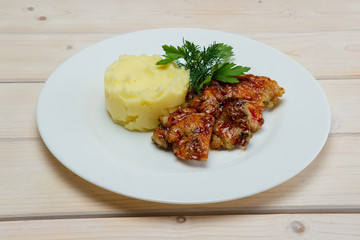 Portion of delicious fried meat in honey sauce with mashed potato