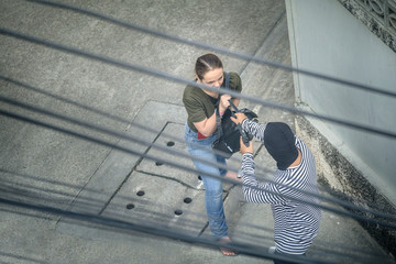 Thief robbery woman with gun ,Dangerous criminal of women in the city. A woman is so scared. thief...