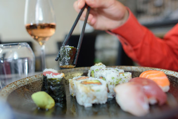 Sushi being picked up with chopsticks
