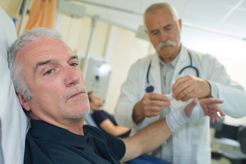 Fototapeta premium senior doctor giving bandaging patient