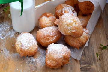 French doughnuts Beignet covered with sugar powder on a wooden table