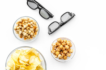 Fast food for watching film. Crisps, popcorn, rusks near glasses on white background top view copyspace