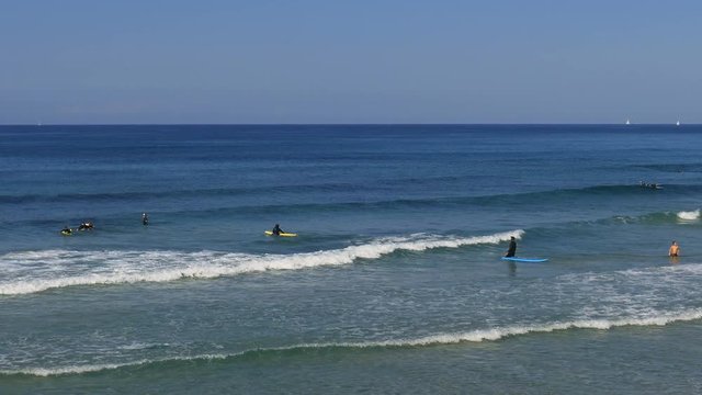 Surfers at Mediterranean sea in Israel at december