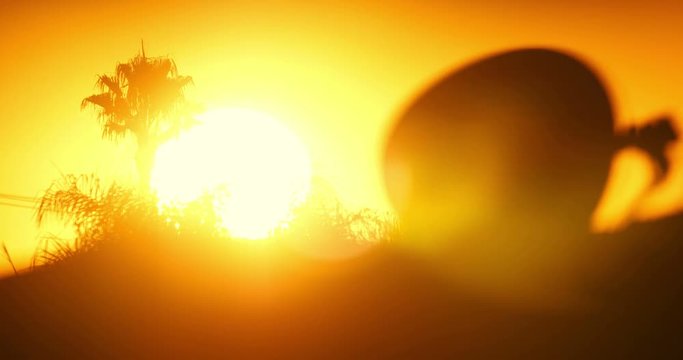 Telephoto shot of morning sunrise sun rising over rooftop line. Los Angeles