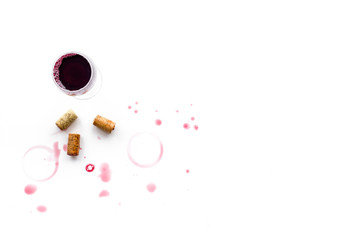 Traces of wine near glass of beverage on white background top view copyspace