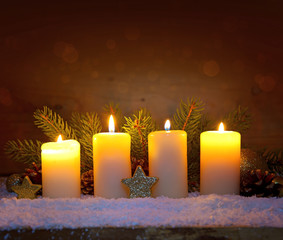 Four burning advent candles and luminous lights.