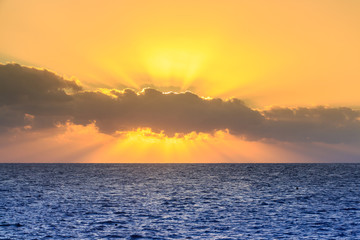 Fototapeta premium Rising in the clouds the sun. The red sea. Egypt.