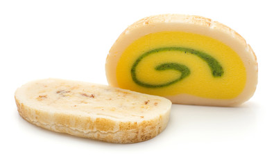Two marzipan slices isolated on white background pineapple citron rum almonds tastes yellow green beige colours.