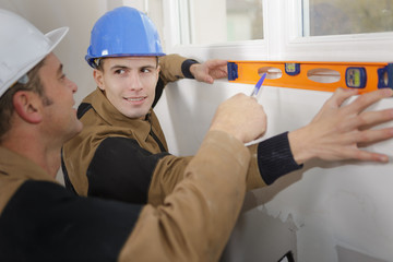 Young man learning to use spirit level