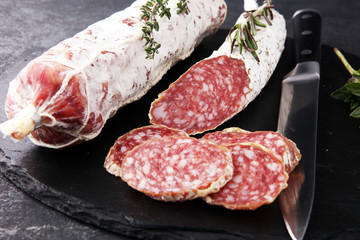 Marble cutting board with sliced salami on it