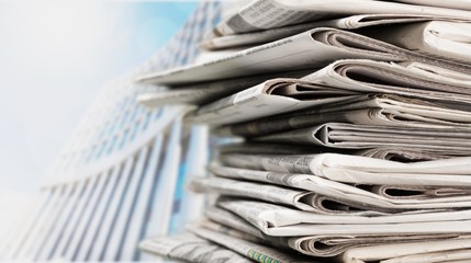 Stack of newspapers on background