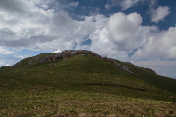 Fototapeta na wymiar The formation and movement of clouds over the summer slopes of Adygea Bolshoy Thach and the Caucasus Mountains