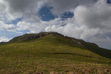 Fototapeta premium The formation and movement of clouds over the summer slopes of Adygea Bolshoy Thach and the Caucasus Mountains