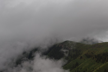 The formation and movement of clouds over the summer slopes of Adygea Bolshoy Thach and the Caucasus Mountains