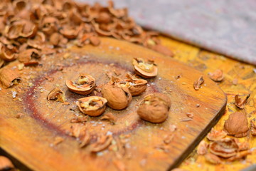 Whole walnuts in a bowl closeup. Whole walnuts, halves of nuts and walnut leaves.