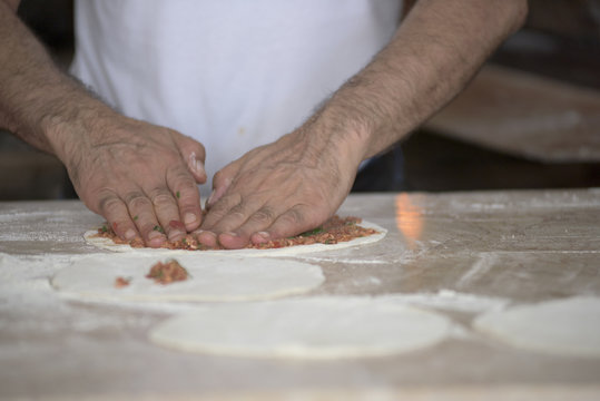 Man Preparing Lahmacun Dough With Hands on the Kitchen Desk