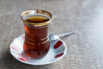 Turkish Tea in Traditional Style Glass With Spoon On the Table