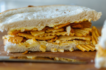 A crisp sandwich comprising a packet of ridged crisps inside two slices of plain or batch bread (including the heel, which everyone knows is the best part).