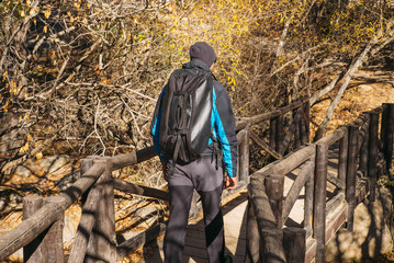 man walk  wooden bridge