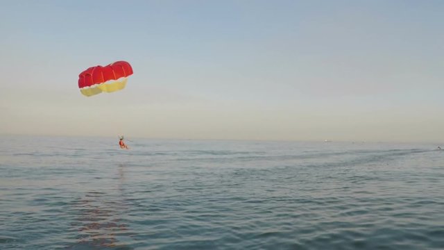 Parasailing. The paratrooper falls into the water.